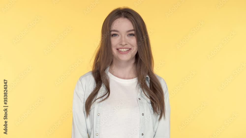 Portrait of smiling and laughing young woman. Yellow background. Portrait of smiling and laughing young woman. Yellow background.