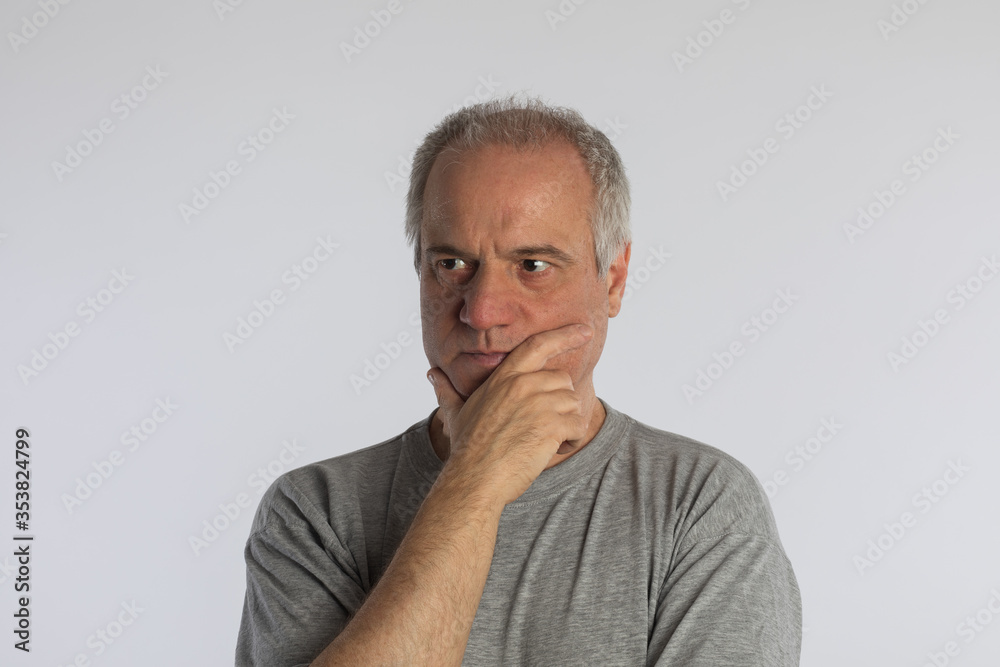 Mature adult in isolated contemplation on white background.