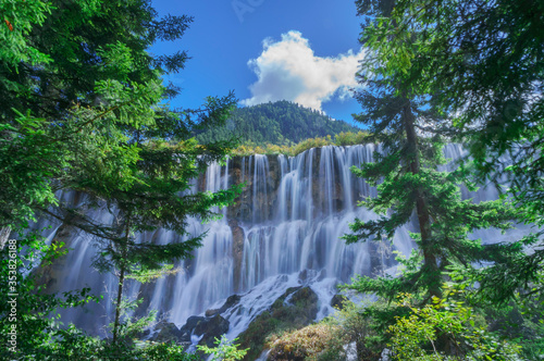 Beautiful and fresh scenery at  waterfall with stacking cascade  green algae  moss and trees at Jiuzhaigou Valley National Park.