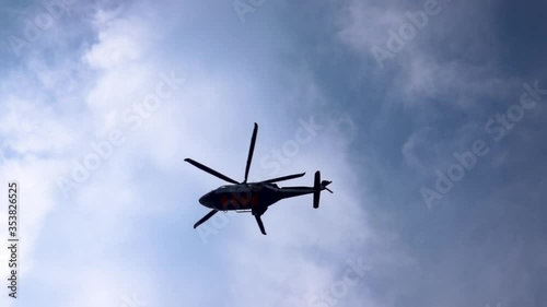 Low angle view of slow motion helicopter moving, Helicopter is one of air transportation, transfer workers to offshore oil and gas platform, air transportation for support passengers. photo