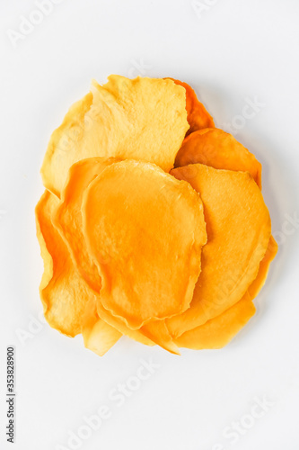 Mango chips on a white background. Dried and fresh mango on a white background.