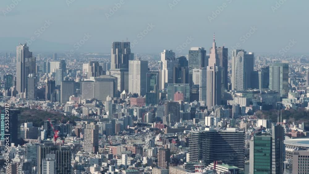 Aerial view of Shinjuku district, Tokyo, Japan. Zoom out camera, 4K time-lapse.