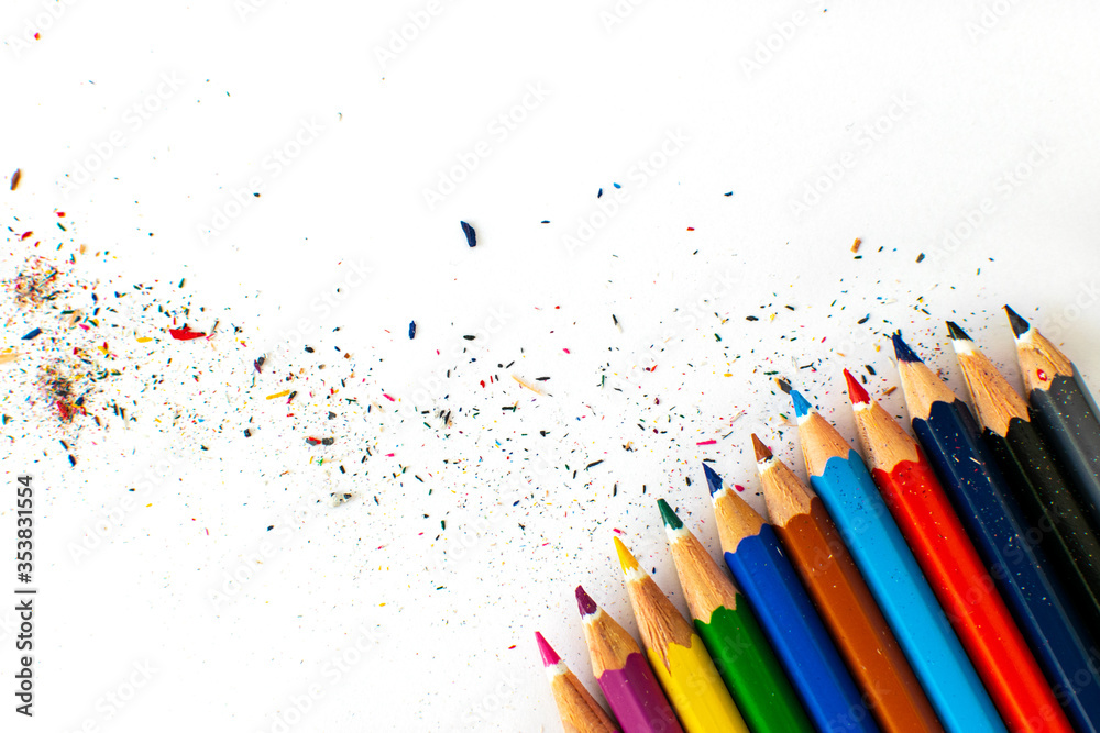 abstract colorful background with colorful pencils and small pencil scraps