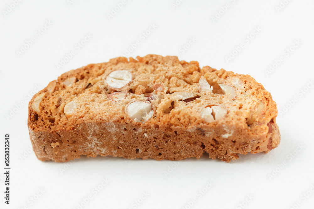Popular Italian Biscotti or Cantucci biscuit cookie stuffed with nuts isolated on white background with copy space.Side view closeup Popular Italian Biscotti or Cantucci biscuit cookie stuffed with nuts isolated on white background with copy space.Side view closeup