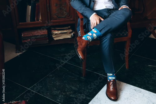 The man wears shoes. Tie the laces on the shoes. Men's style. Professions. To prepare for work, to the meeting.