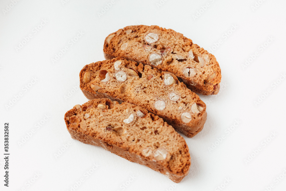 Three famous Italian Biscotti or Cantucci cookies stuffed with nuts  isolated on white background.