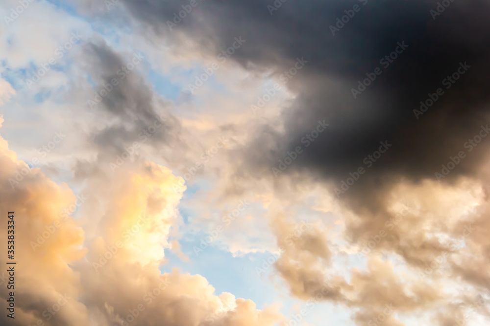Colorful sunset sky above dark clouds with dramatic light before raining in twilight time . Beautiful sunset background