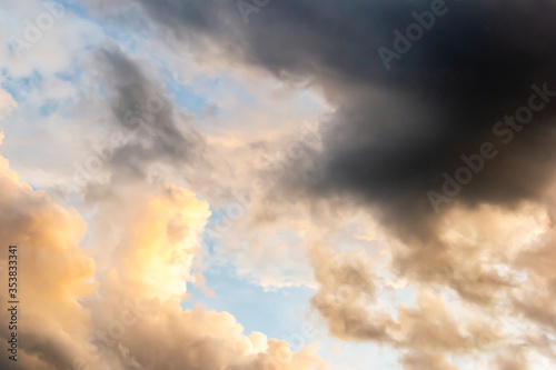 Colorful sunset sky above dark clouds with dramatic light before raining in twilight time . Beautiful sunset background