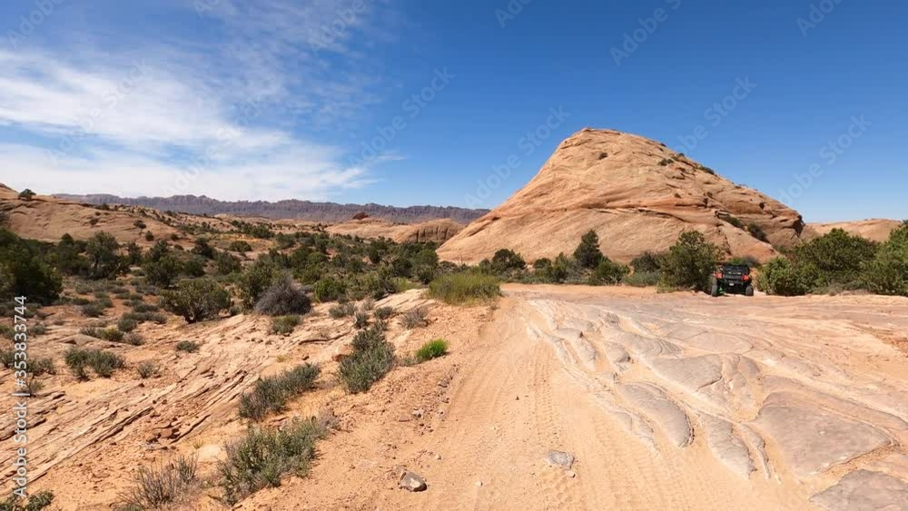Rough rocky trail Moab Utah desert off road recreation POV 4K. In south eastern Utah desert. Tourists and visitors worldwide come to nearby Arches and Canyonlands National Parks. Rough rocky trail Moab Utah desert off road recreation POV 4K. In south eastern Utah desert. Tourists and visitors worldwide come to nearby Arches and Canyonlands National Parks.