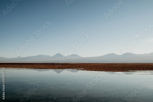 Quietly situated sea with a view of distant mountains on the horizon
