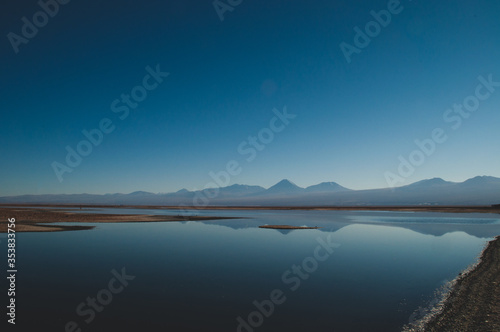 Quietly situated sea with a view of distant mountains on the horizon