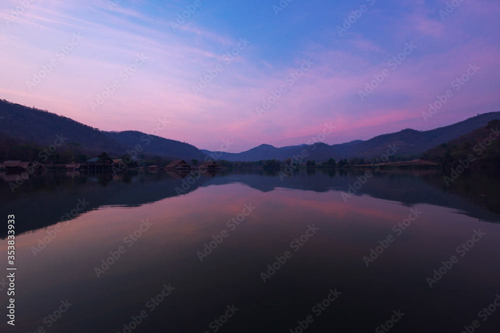 Bamboo houses with mountain on the calm lake backgroud in the morning at Khao wong reservoir, Suphanburi province, Thailand Bamboo houses with mountain on the calm lake backgroud in the morning at Khao wong reservoir, Suphanburi province, Thailand