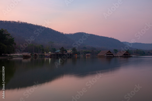 Bamboo houses with mountain on the calm lake backgroud in the morning at Khao wong reservoir, Suphanburi province, Thailand