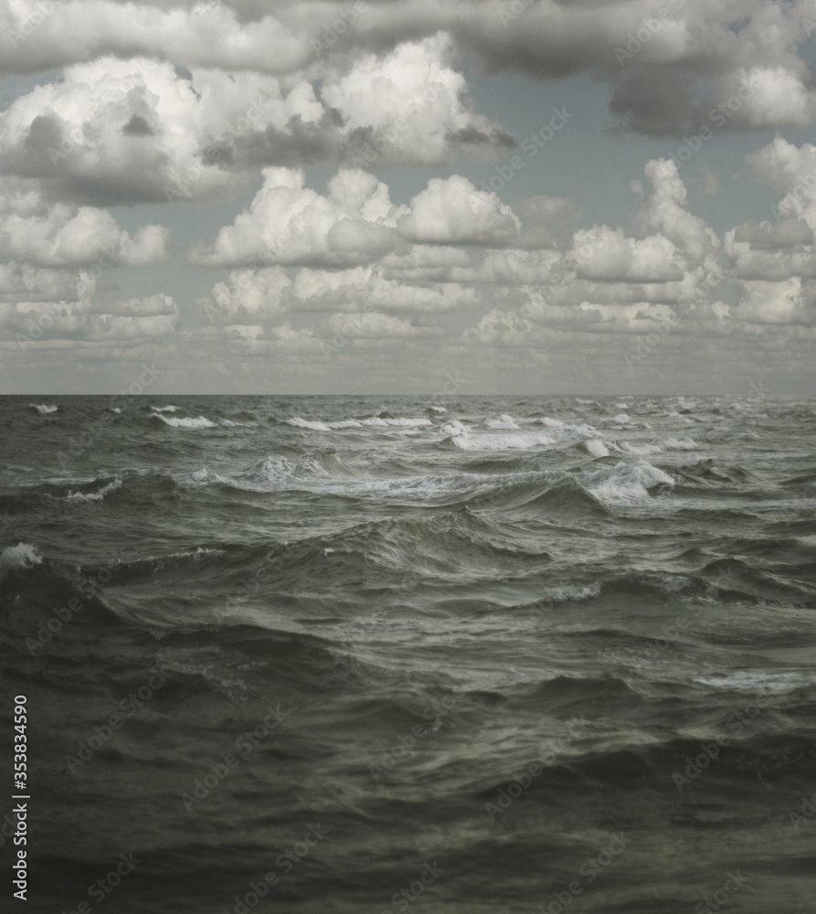 Fototapeta premium White fluffy clouds over the sea or ocean summer background