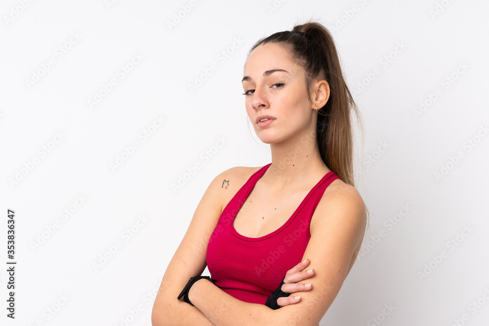 Young sport brunette woman over isolated white background keeping the arms crossed Young sport brunette woman over isolated white background keeping the arms crossed
