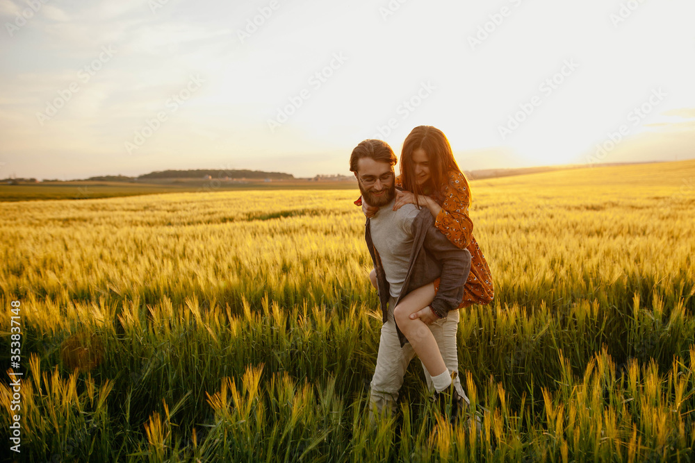 young happy couple in a barley field at sunset. girl in a yellow dress and a guy with a beard.
portrait of couple walking in the grass young happy couple in a barley field at sunset. girl in a yellow dress and a guy with a beard.
portrait of couple walking in the grass