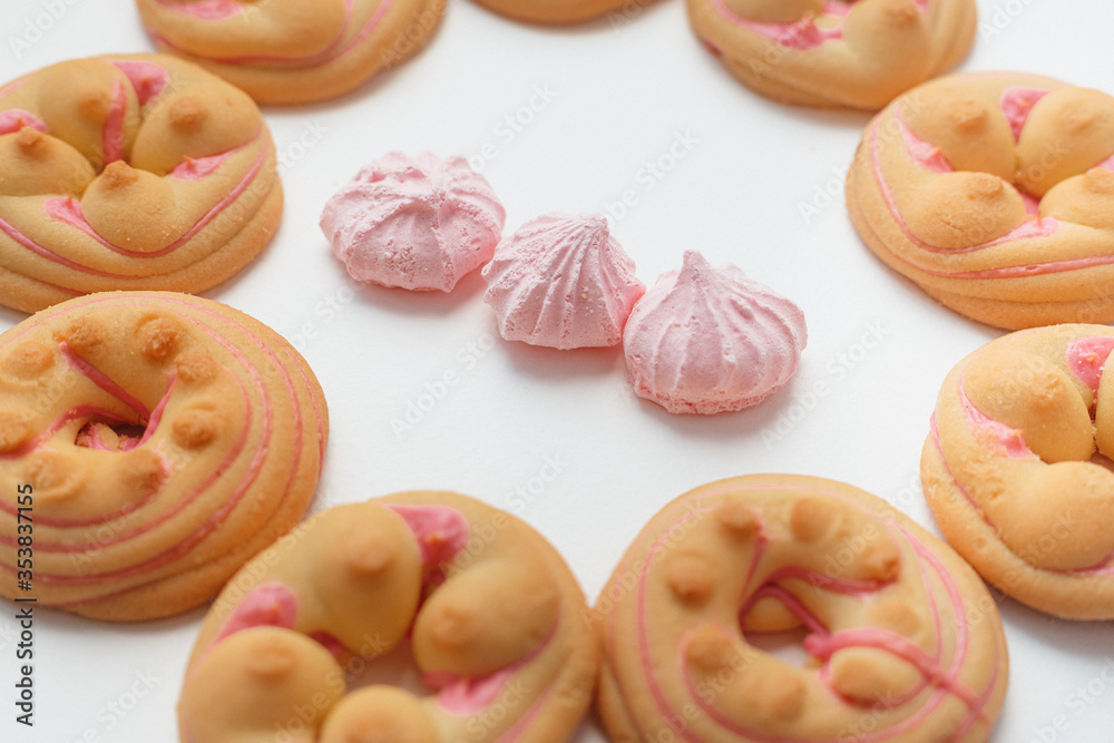 Cookie biscuit with pink sugar cream icing isolated on white background Cookie biscuit with pink sugar cream icing isolated on white background