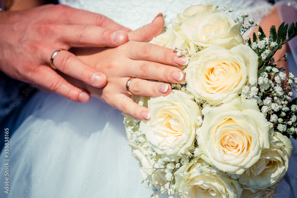 newlyweds, close-up hands with rings, joined together, hold hands