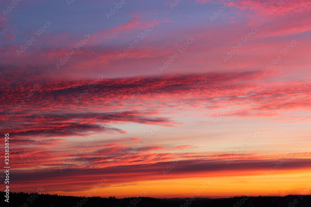 Dramatic sky at sunset, natural color of evening cloudscape with setting sun rays highlighting clouds. Sky and clouds in bright rainbow colors, colorful sky in dusk. Majestic purple sky Dramatic sky at sunset, natural color of evening cloudscape with setting sun rays highlighting clouds. Sky and clouds in bright rainbow colors, colorful sky in dusk. Majestic purple sky