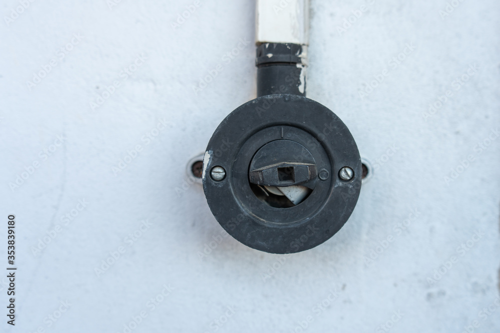 Old style rotary light on a white painted wall Old style rotary light on a white painted wall