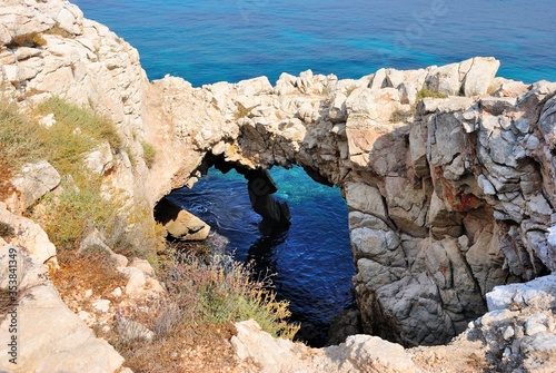 Natural rock bridge at the Lara Bay on Akamas peninsula with the turquoise waters of Mediterranean Sea in northwest extremity of Cyprus