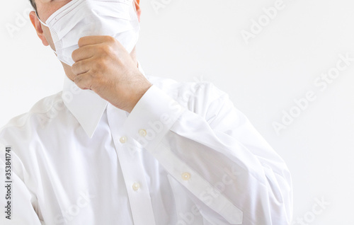マスクをつけ咳する、ワイシャツを着た男性