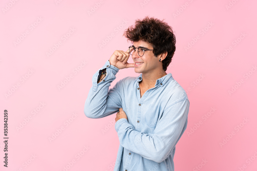 Young caucasian man over isolated pink background with glasses Young caucasian man over isolated pink background with glasses