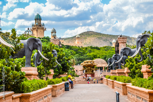 Entrance of The Palace / Lost City /Sun City with stone statues under blue and cloudy sky