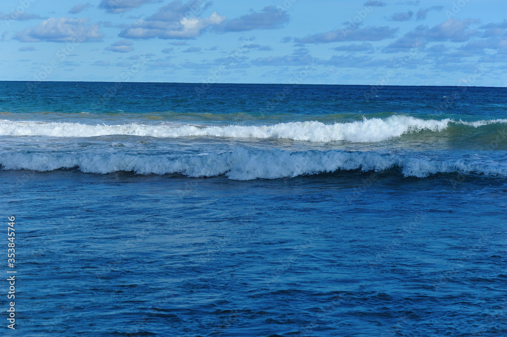 Beautiful strong sea waves under blue sky