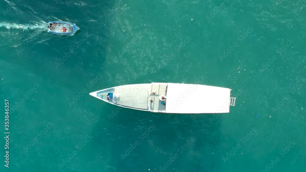Aerial drone clip of dive boat and small dingy from above Aerial drone clip of dive boat and small dingy from above