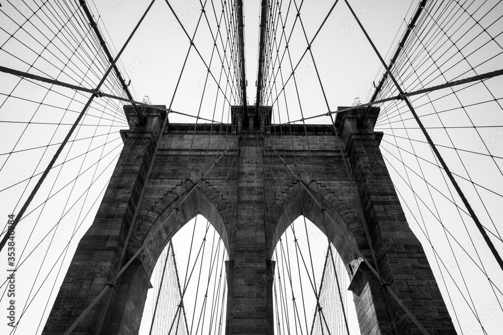 Fototapeta premium Brooklyn Bridge in black and white with lots of symmetry shot in September 2019, New York USA