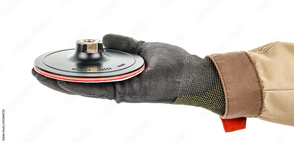 Sanding paper disc on quick release holder for angle grinder lies in palm of male hand in black protective glove and brown uniform isolated on white background Sanding paper disc on quick release holder for angle grinder lies in palm of male hand in black protective glove and brown uniform isolated on white background