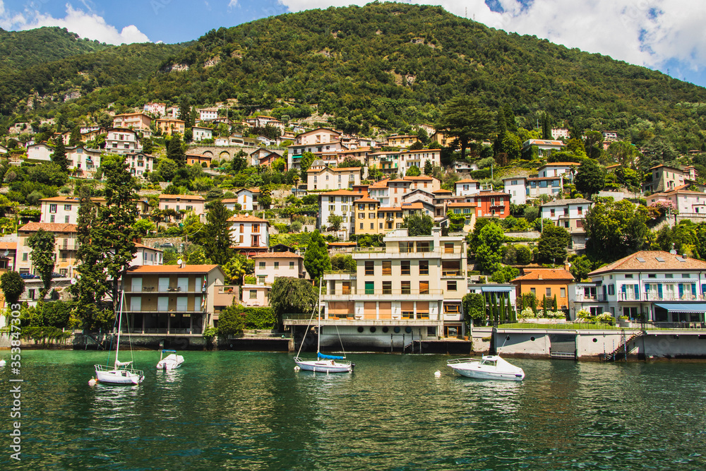 Houses at the border of Lake Como Italy situated between the water and the mountains in July 2019