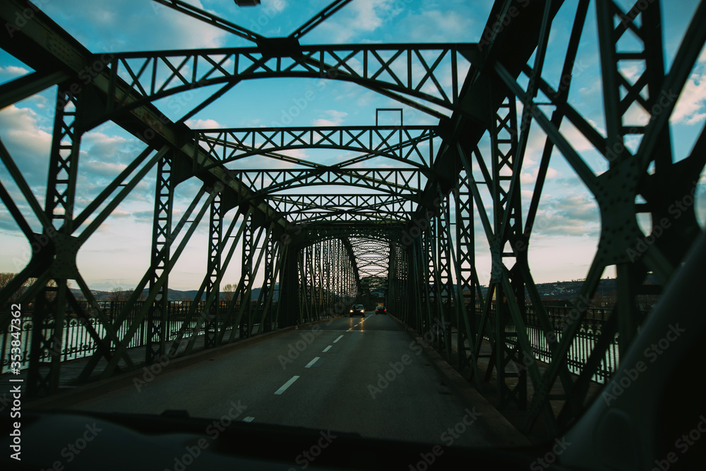 Tunel of a dark metal bridge for cars over a river Tunel of a dark metal bridge for cars over a river