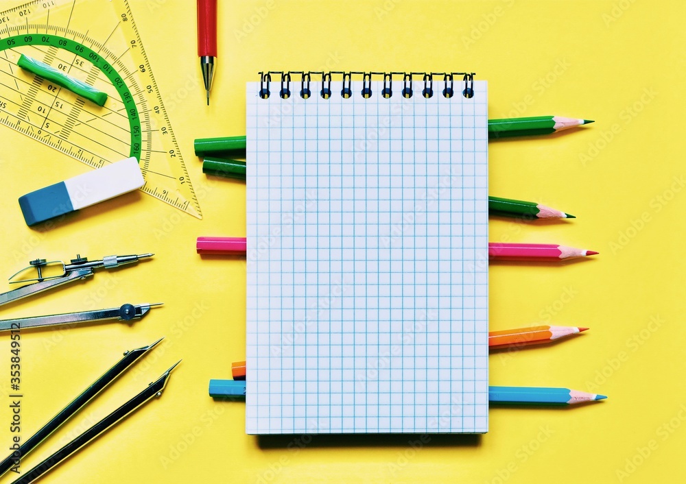 School stationery and space for text on a yellow background. The view from the top. School stationery and space for text on a yellow background. The view from the top.