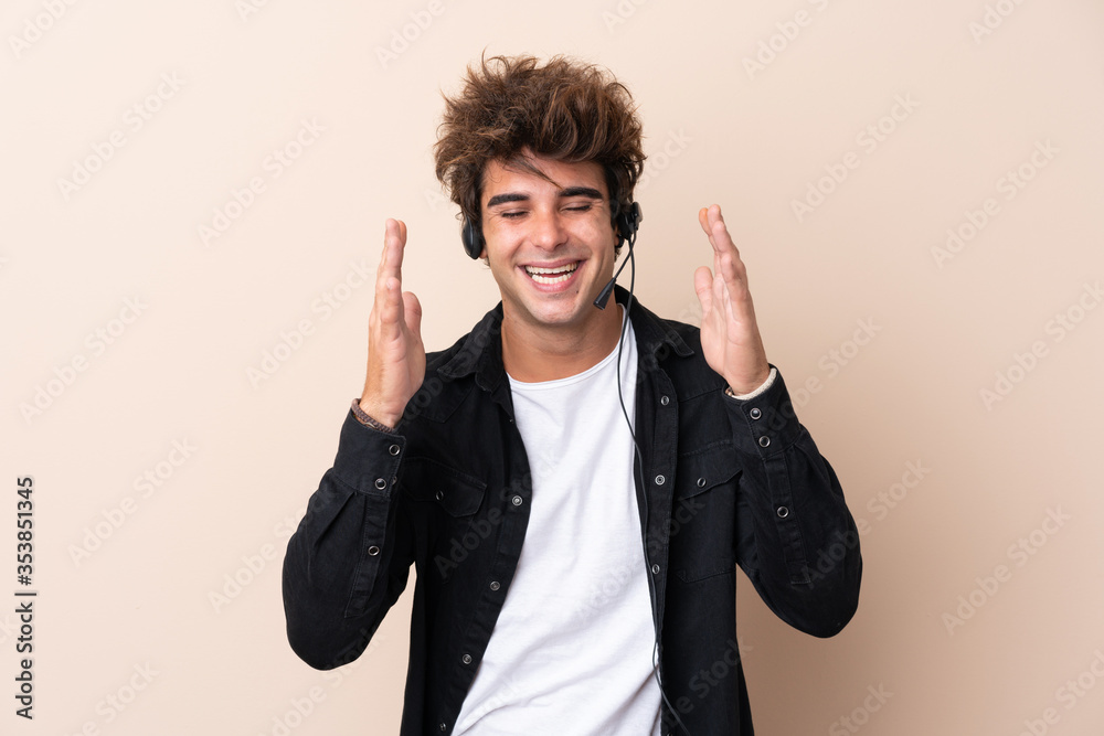 Telemarketer man working with a headset over isolated background laughing Telemarketer man working with a headset over isolated background laughing