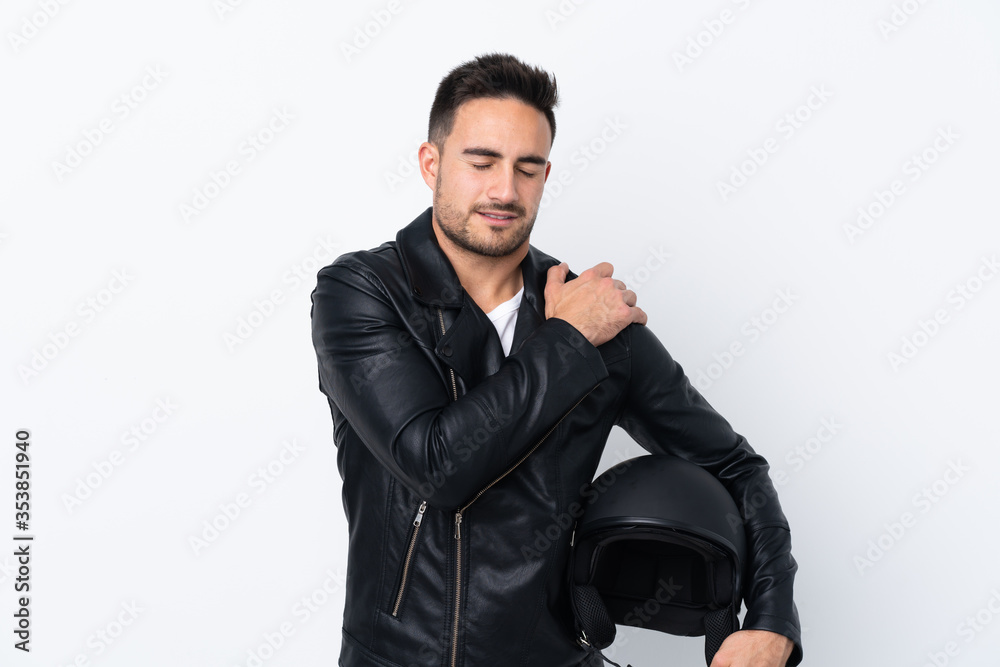 Man with a motorcycle helmet suffering from pain in shoulder for having made an effort Man with a motorcycle helmet suffering from pain in shoulder for having made an effort