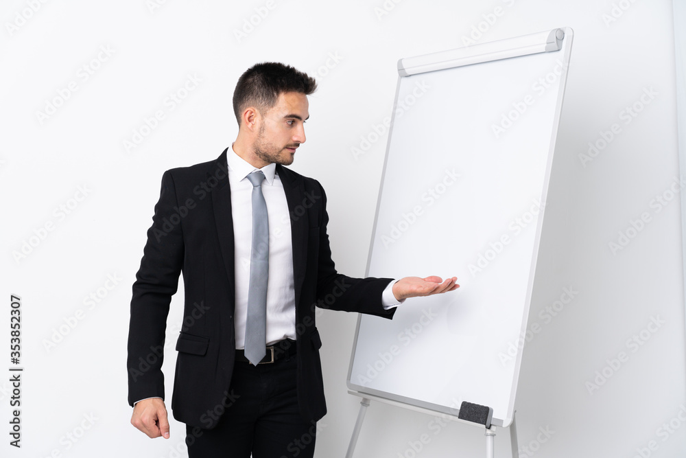 Young man giving a presentation on white board Young man giving a presentation on white board