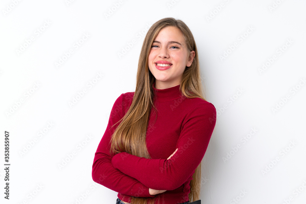 Teenager blonde girl over isolated white background with arms crossed and looking forward Teenager blonde girl over isolated white background with arms crossed and looking forward