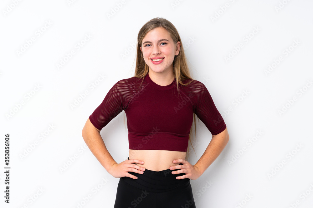 Sport teenager girl over isolated white background posing with arms at hip and smiling Sport teenager girl over isolated white background posing with arms at hip and smiling