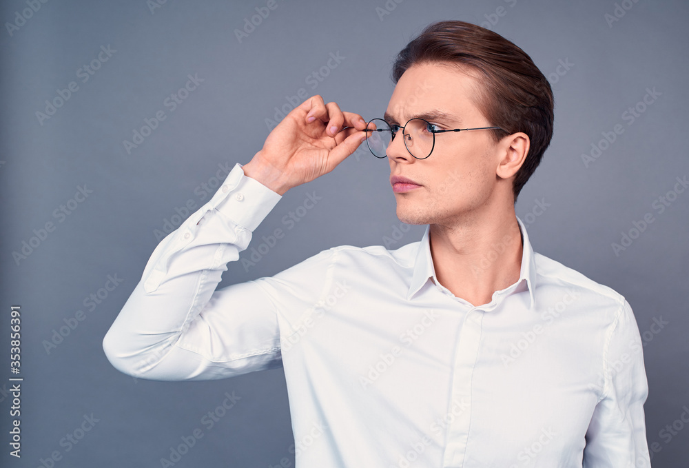 Portrait of a handsome young businessman in a white shirt and glasses. Portrait of a handsome young businessman in a white shirt and glasses.