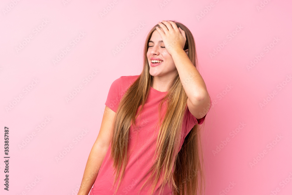 Teenager blonde girl over isolated pink background laughing Teenager blonde girl over isolated pink background laughing