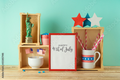 Happy Independence Day, 4th of July celebration concept with photo frame and patriotic home decor on wooden table