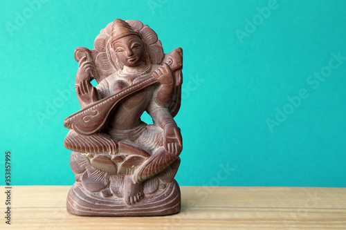 Figurine of the Hindu goddess Sarasvati. The goddess of knowledge and wisdom is Saraswati. photo