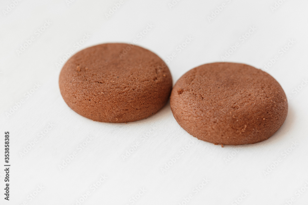 Two round brown chocolate cookies on white background Two round brown chocolate cookies on white background