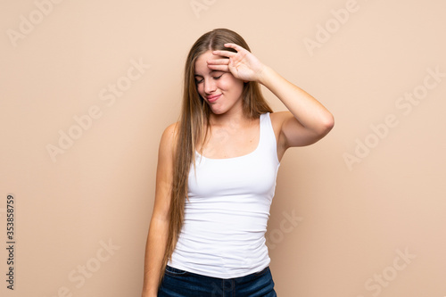 Teenager blonde girl over isolated background with tired and sick expression