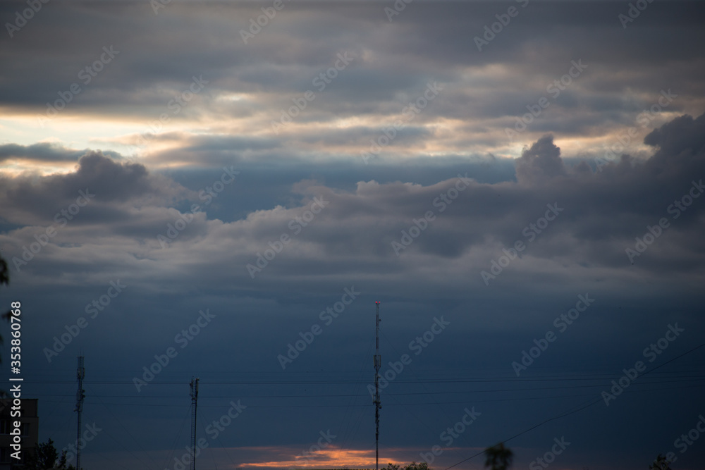 Fluffy clouds cover the summer blue sky