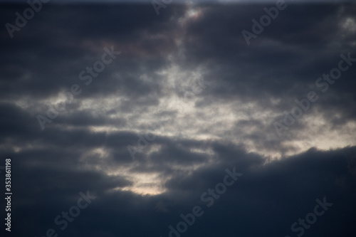 Fluffy clouds cover the summer blue sky