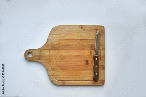 wooden chopping board with a knife