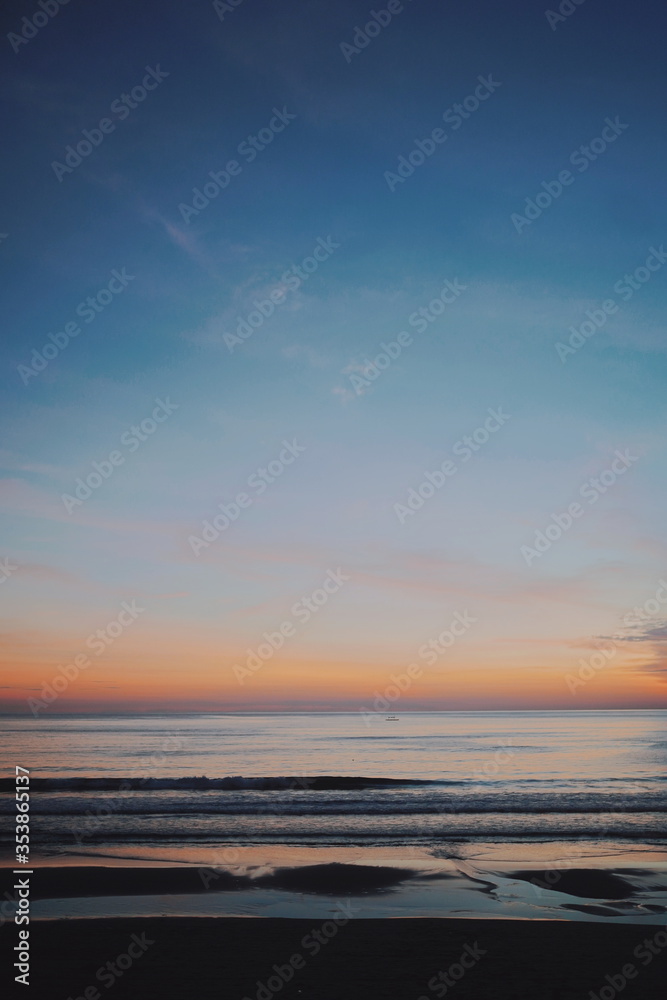 Beautiful horizon view and color cast during sunset at the beach of Bali island